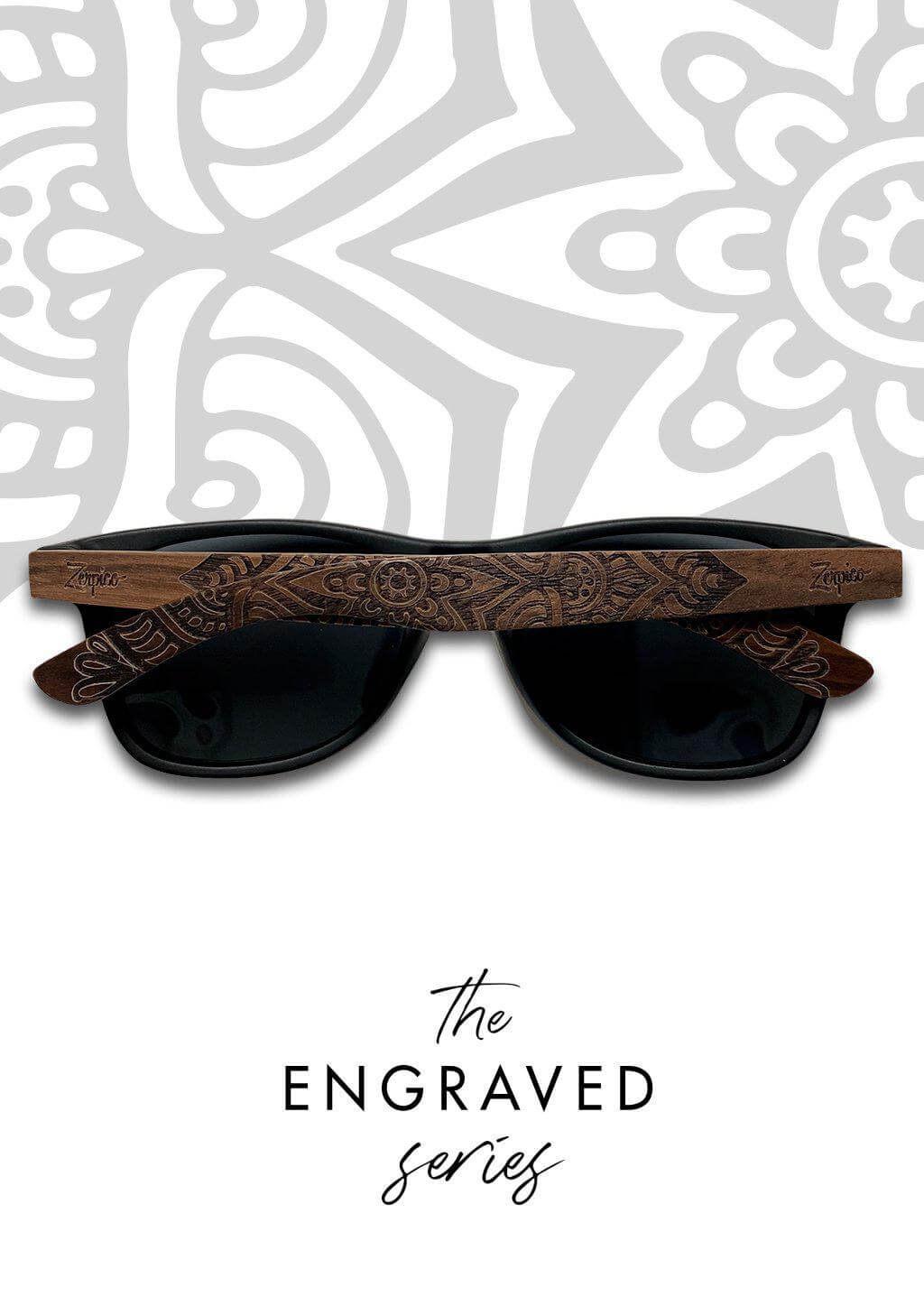 Engraved wooden sunglasses with mandala pattern held up outdoors, ideal for camping and adventures at revlando.com.